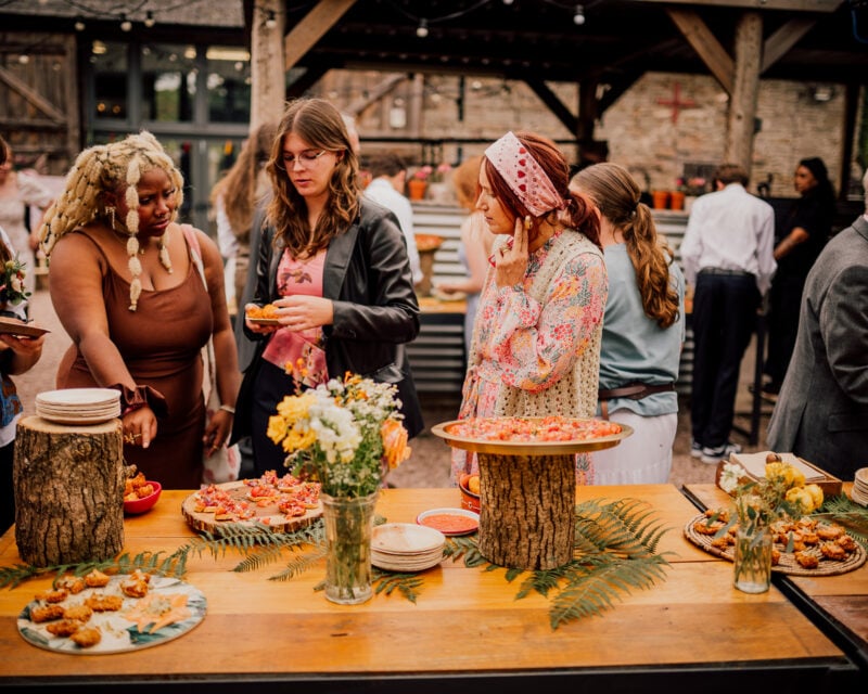Guests gathered in the rustic courtyard at Drovers Rest, enjoying fire-cooked food and relaxed outdoor dining in Herefordshire.