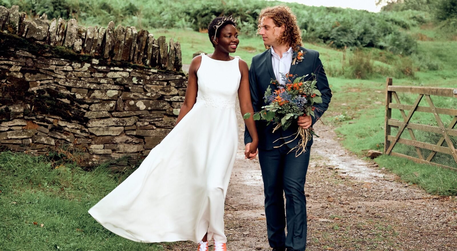 Black Bride and white groom standing together in nature at Drovers Rest