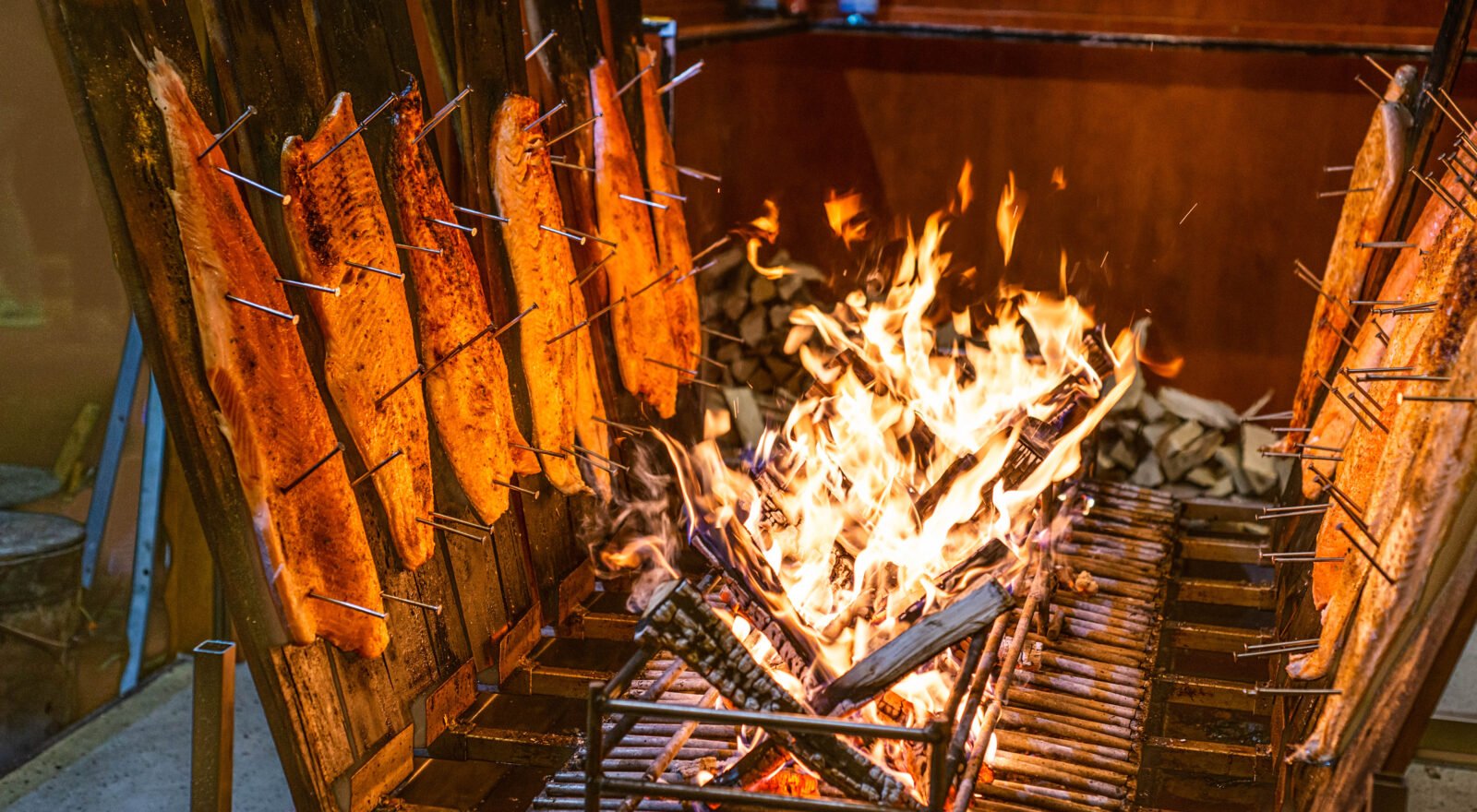 almon cooked on cedar planks over an open fire, infused with smoky, wood-fired flavour.