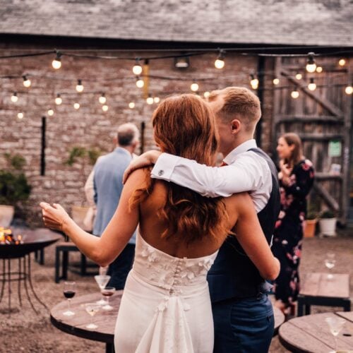 Fire-lit courtyard at dusk with twinkly lights and cocktails at Drovers Rest
