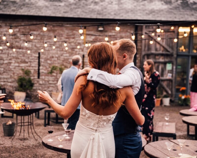 Fire-lit courtyard at dusk with twinkly lights and cocktails at Drovers Rest