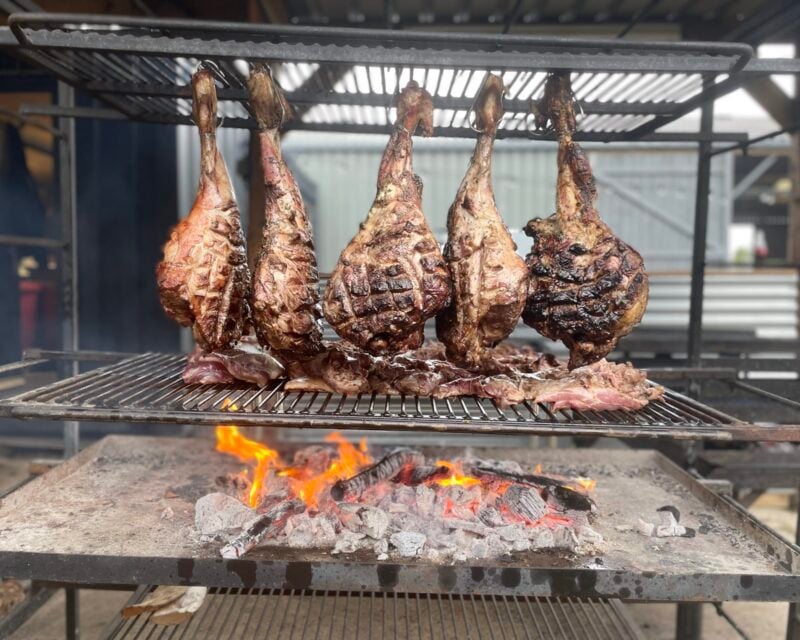 Legs of lamb cooking over open fires at Drovers Rest