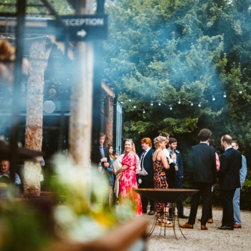People gathering in the courtyard at Drovers Rest with smoke in the air