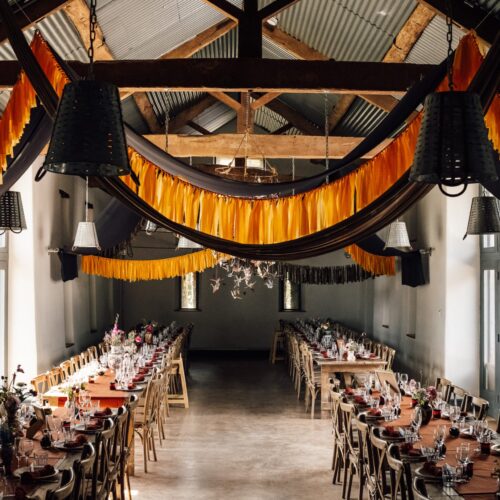Posh Barn set for an event with long tables and bunting at Drovers Rest